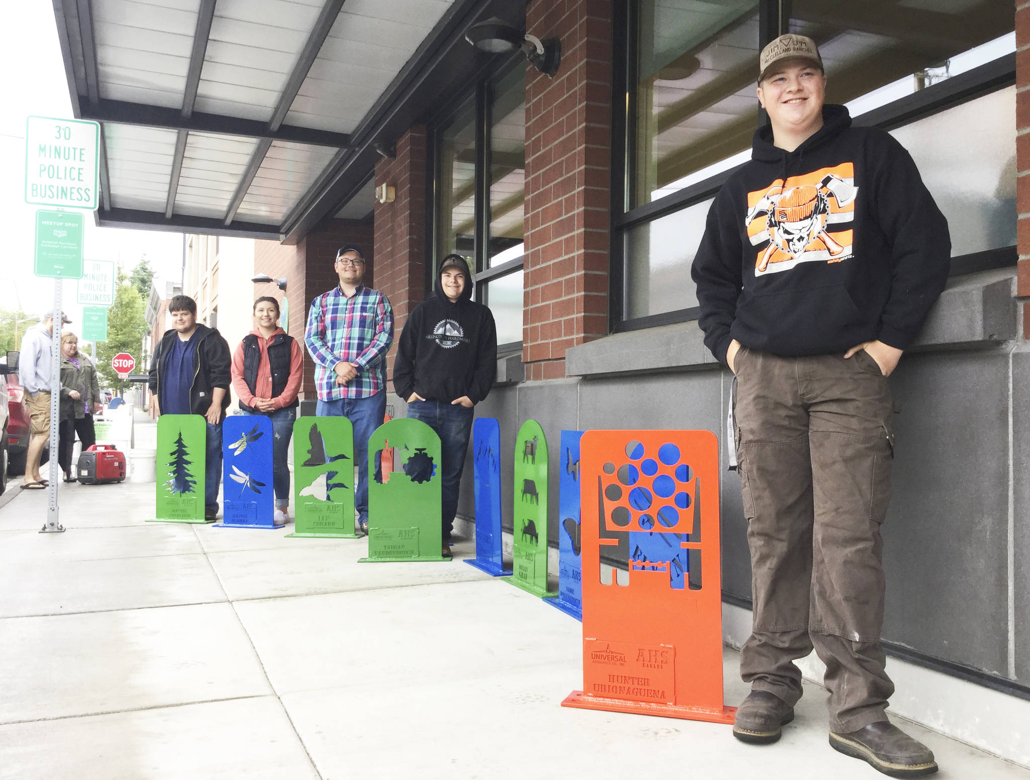 Arlington High School engineering and welding class students stand behind the bike racks each designed individually for downtown. City workers installed them Wednesday. Pictured from left are Daniel Novacek, Haylei Osborn, Ian Seward, Taegan Vandenbosch and Hunter Urionaguena.