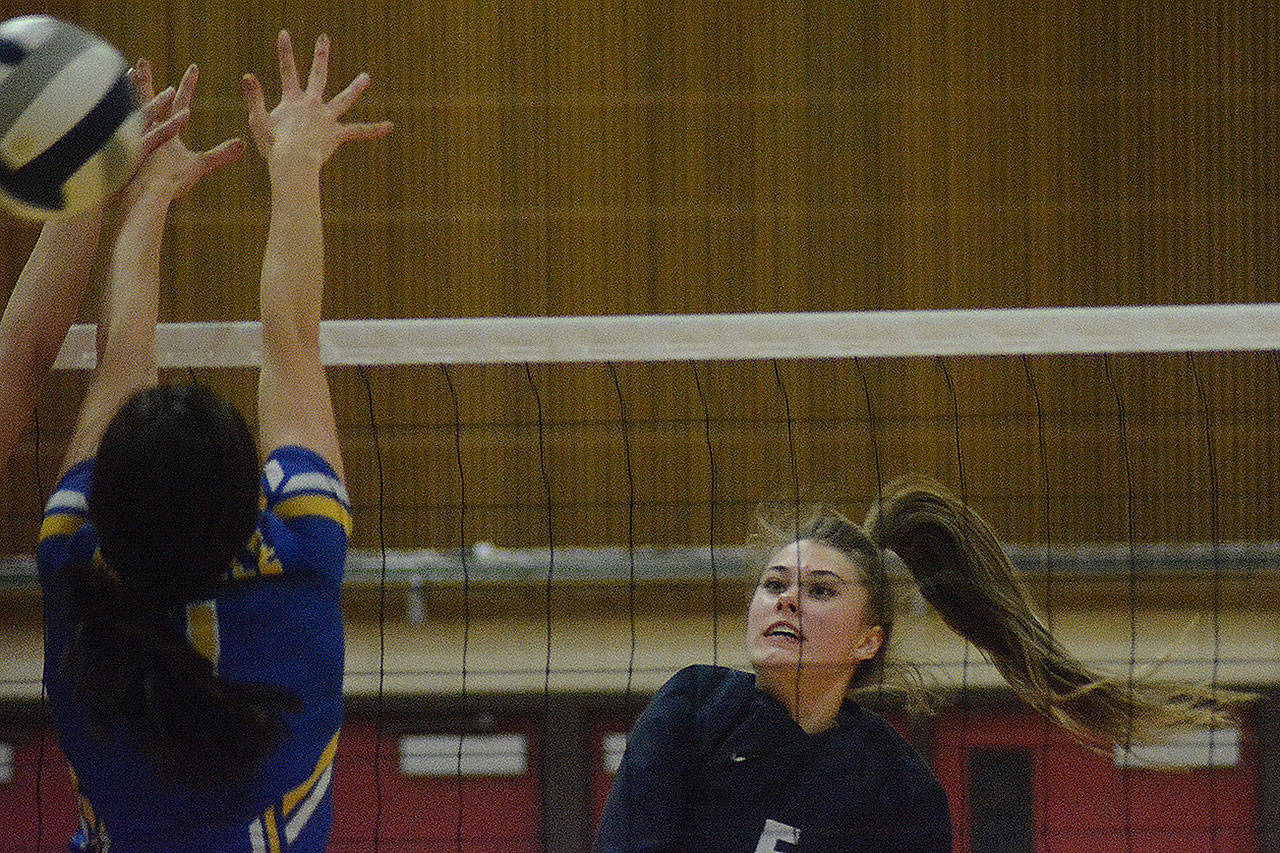 Emily Mekelburg spikes the ball in a recent playoffs match.