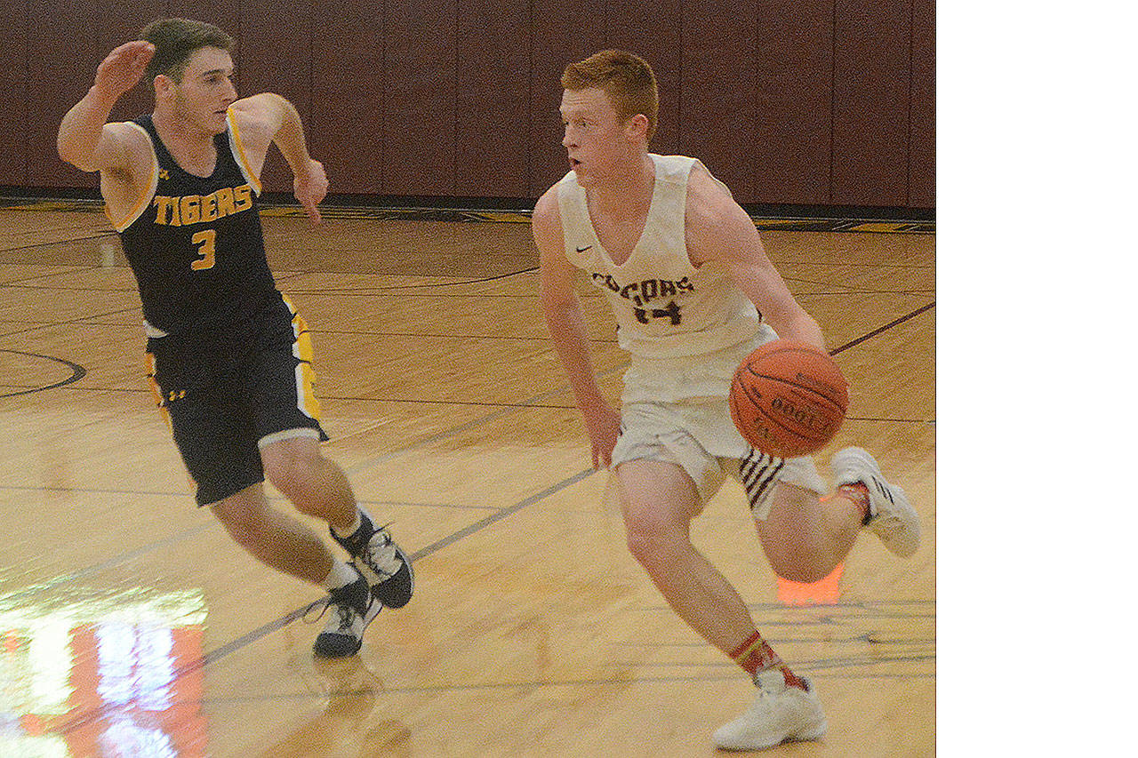 Alex Jensen drives past a Tiger from B-E.