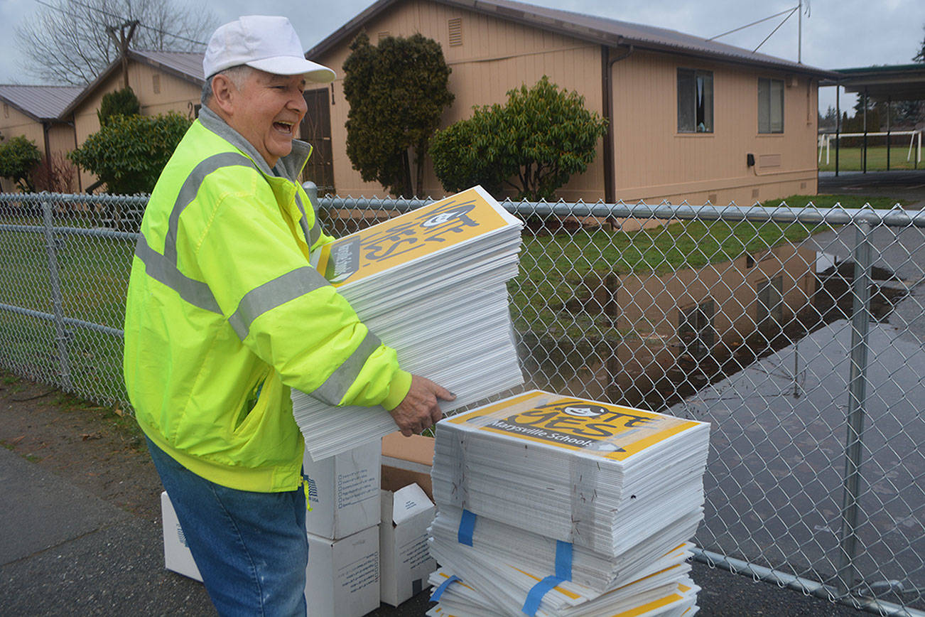 Steve Powell/Staff Photo                                Dean Ledford gets signs ready to be picked up by volunteers.