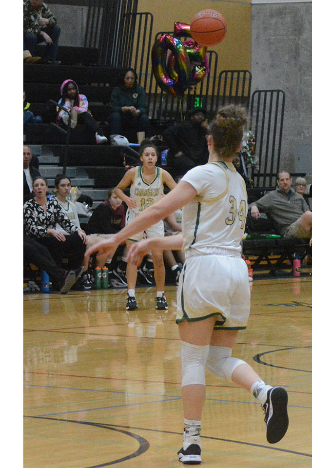 Ellie Jackson (12) receives pass from teammate Maddy Grandbois. Jackson scored 26 points to help the Chargers advance to play tonight at Arlington. (Steve Powell/File Photo)