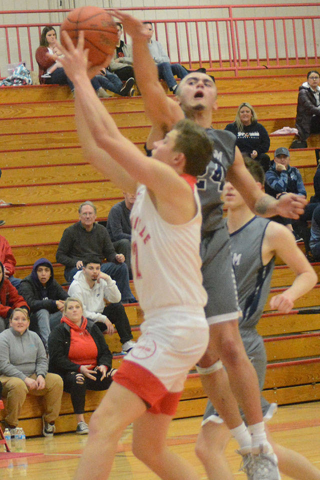 Steve Powell/Staff PhoTOS                                Aaron Kalab of M-P gets a shot blocked while Josiah Koellmer of MG tries to split two Arlington defenders.