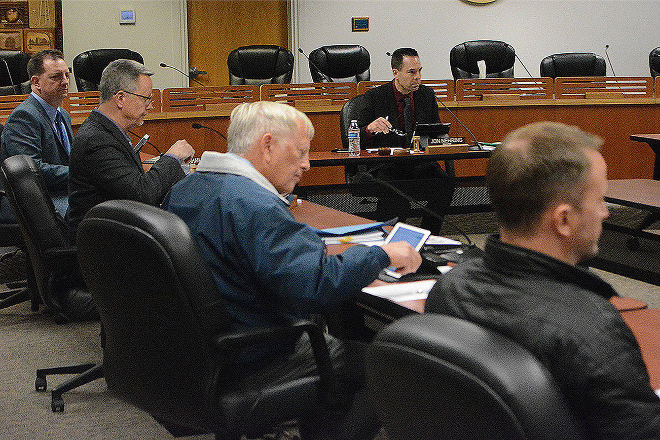 The mayor and council members were seated 6 feet apart at the meeting.