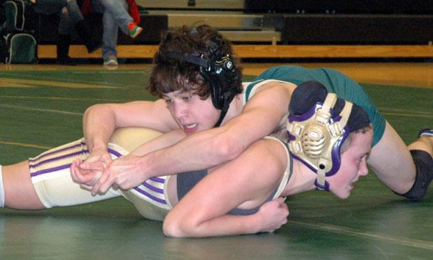 Marysville Getchell wrestler Billy Almachar struggles to pin Oak Harbor’s Kylene Ayer on Jan. 24.