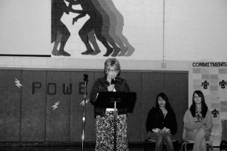 School Principal Judy Albertson led what officials dubbed a commitment assembly at the school last week. Joining her for part of the program were students Chelsea Harbo and Farrah Wolgamott.